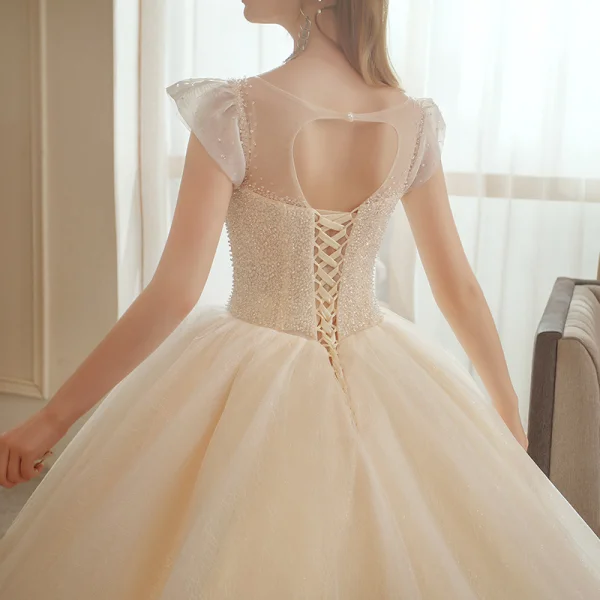 Meilleur La Mariée Champagne Transparentes Robe De Mariée 2020 Robe Boule Encolure Dégagée Sans Manches Dos Nu Perlage Glitter Tulle Cathedral Train Volants