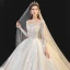 Meilleur Champagne La Mariée Robe De Mariée 2020 Robe Boule Transparentes Encolure Dégagée Manches Longues Dos Nu Appliques En Dentelle Perlage Glitter Tulle Cathedral Train Volants