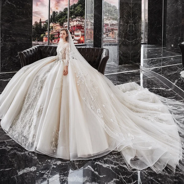 Luxury / Gorgeous Champagne See-through Bridal Wedding Dresses 2020 Ball Gown Scoop Neck Long Sleeve Backless Appliques Flower Beading Glitter Tulle Cathedral Train Ruffle