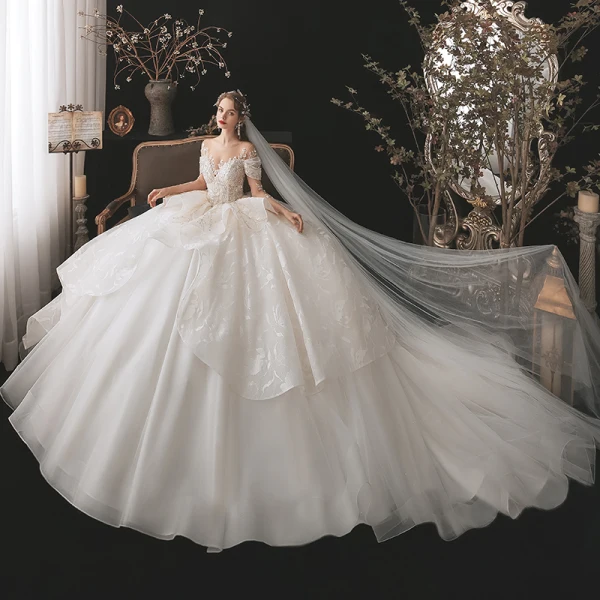 Luxury / Gorgeous Bridal Champagne Wedding Dresses 2020 Ball Gown See-through Scoop Neck Long Sleeve Backless Appliques Lace Beading Sequins Cathedral Train Ruffle