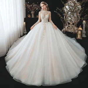 Romántico Champán Boda Vestidos De Novia 2020 Ball Gown Transparentes Cuello Alto Manga Larga Sin Espalda Rebordear Glitter Tul Cathedral Train Ruffle