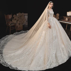 Haut De Gamme Champagne La Mariée Robe De Mariée 2020 Robe Boule Transparentes Encolure Dégagée Manches Longues Dos Nu Appliques En Dentelle Perlage Glitter Tulle Cathedral Train Volants