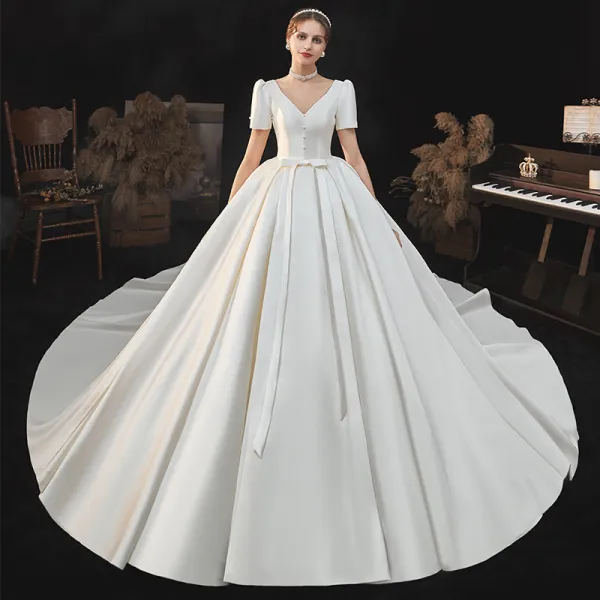 Vintage / Retro Ivory Satin Bridal Wedding Dresses 2020 Ball Gown V-Neck Puffy Short Sleeve Backless Beading Pearl Bow Cathedral Train Ruffle