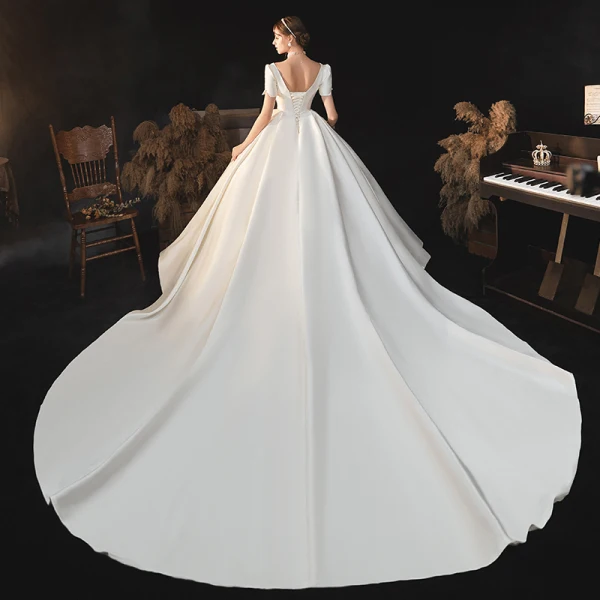 Vintage / Retro Ivory Satin Bridal Wedding Dresses 2020 Ball Gown V-Neck Puffy Short Sleeve Backless Beading Pearl Bow Cathedral Train Ruffle