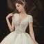 Romantique Champagne La Mariée Robe De Mariée 2020 Robe Boule Transparentes Col v profond Manches Courtes Dos Nu Appliques En Dentelle Perlage Glitter Tulle Cathedral Train Volants