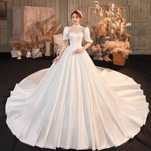 Vintage / Retro Ivory Satin See-through Bridal Wedding Dresses 2020 Ball Gown High Neck Puffy Short Sleeve Backless Bow Beading Pearl Cathedral Train Ruffle