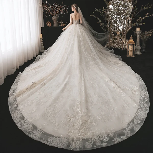 Romantic Champagne See-through Bridal Wedding Dresses 2020 Ball Gown Scoop Neck Long Sleeve Backless Appliques Lace Beading Glitter Tulle Cathedral Train Ruffle