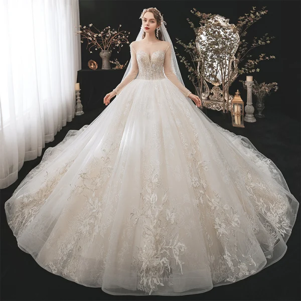 Romantic Champagne See-through Bridal Wedding Dresses 2020 Ball Gown Scoop Neck Long Sleeve Backless Appliques Lace Beading Glitter Tulle Cathedral Train Ruffle