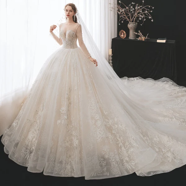 Romantic Champagne See-through Bridal Wedding Dresses 2020 Ball Gown Scoop Neck Long Sleeve Backless Appliques Lace Beading Glitter Tulle Cathedral Train Ruffle