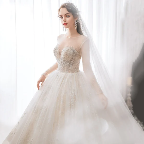 Romantic Champagne See-through Bridal Wedding Dresses 2020 Ball Gown Scoop Neck Long Sleeve Backless Appliques Lace Beading Glitter Tulle Cathedral Train Ruffle