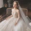 Romantic Champagne See-through Bridal Wedding Dresses 2020 Ball Gown Scoop Neck Long Sleeve Backless Appliques Lace Beading Glitter Tulle Cathedral Train Ruffle