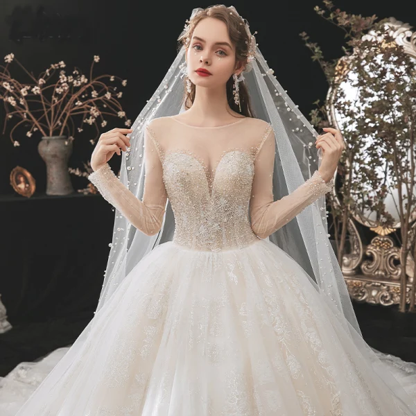 Romantic Champagne See-through Bridal Wedding Dresses 2020 Ball Gown Scoop Neck Long Sleeve Backless Appliques Lace Beading Glitter Tulle Cathedral Train Ruffle