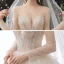 Romantic Champagne See-through Bridal Wedding Dresses 2020 Ball Gown Scoop Neck Long Sleeve Backless Appliques Lace Beading Glitter Tulle Cathedral Train Ruffle