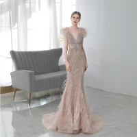 Luxe Champagne Tapis rouge Robe De Soirée 2020 Trompette / Sirène Col v profond Sans Manches Plumes Perlage Train De Balayage Volants Dos Nu Robe De Ceremonie