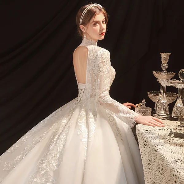 Vintage / Retro Ivory See-through Bridal Wedding Dresses 2021 Ball Gown High Neck Long Sleeve Backless Appliques Lace Beading Pearl Cathedral Train Ruffle