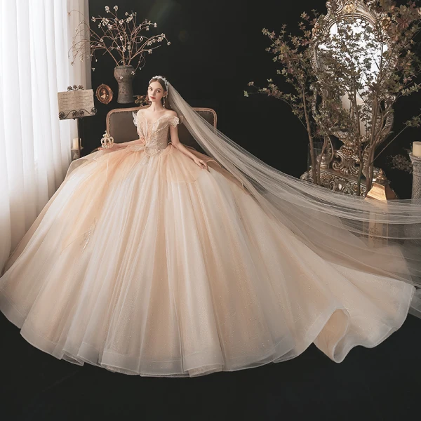 Charmant Champagne Transparentes La Mariée Robe De Mariée 2021 Robe Boule De l'épaule Manches Courtes Dos Nu Appliques En Dentelle Paillettes Perlage Glitter Tulle Cathedral Train Volants