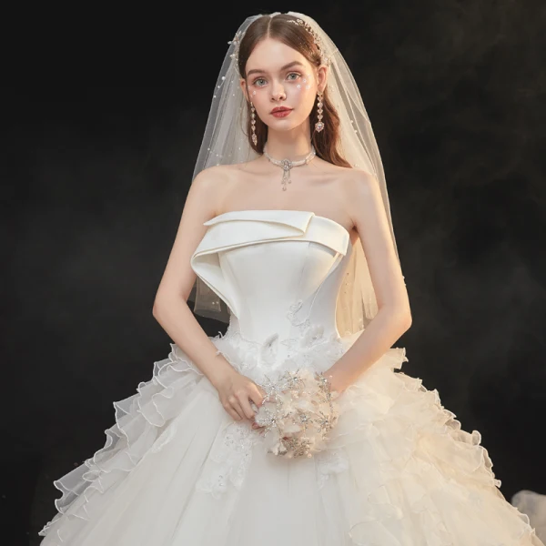 High-end Ivory Organza Bridal Wedding Dresses 2021 Ball Gown Strapless Sleeveless Backless Appliques Lace Sequins Beading Cathedral Train Ruffle