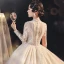 Illusion Champagne See-through Bridal Wedding Dresses 2021 Ball Gown V-Neck Long Sleeve Appliques Lace Beading Tassel Glitter Tulle Royal Train Ruffle