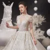 Luxury / Gorgeous Champagne See-through Bridal Wedding Dresses 2020 Ball Gown High Neck Short Sleeve Appliques Lace Beading Tassel Glitter Tulle Cathedral Train