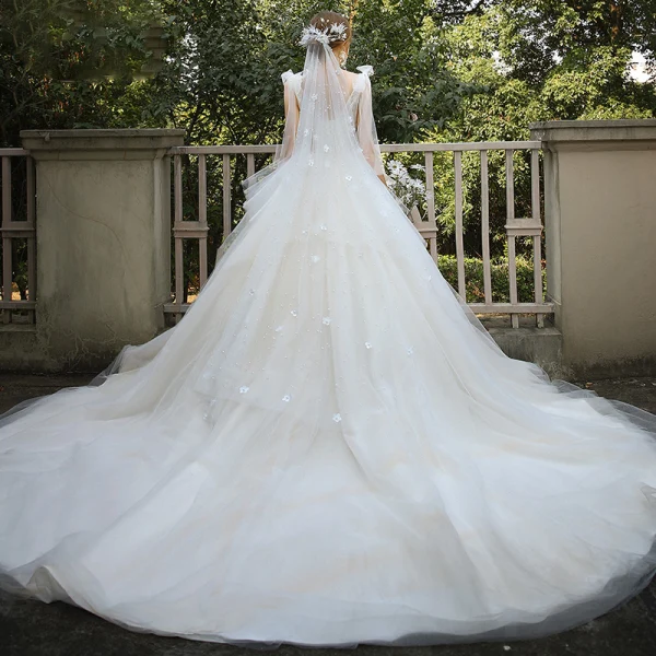 Elegant Champagne Bridal Wedding Dresses 2020 Ball Gown V-Neck Sleeveless Backless Appliques Lace Sequins Beading Cathedral Train Ruffle