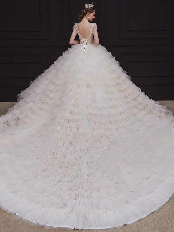 Luxe Champagne La Mariée Robe De Mariée 2020 Robe Boule Transparentes Col v profond Sans Manches Dos Nu Appliques Paillettes Perlage Royal Train Volants en Cascade