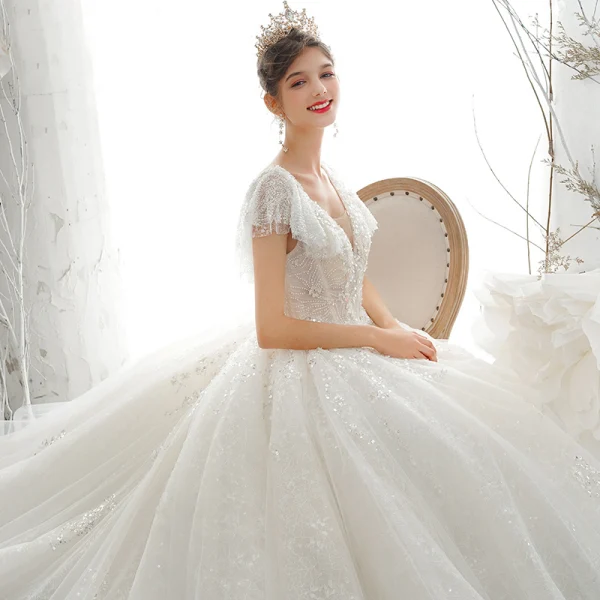 Luxury / Gorgeous Champagne Bridal Wedding Dresses 2020 Ball Gown See-through V-Neck Short Sleeve Backless Appliques Sequins Beading Cathedral Train Ruffle
