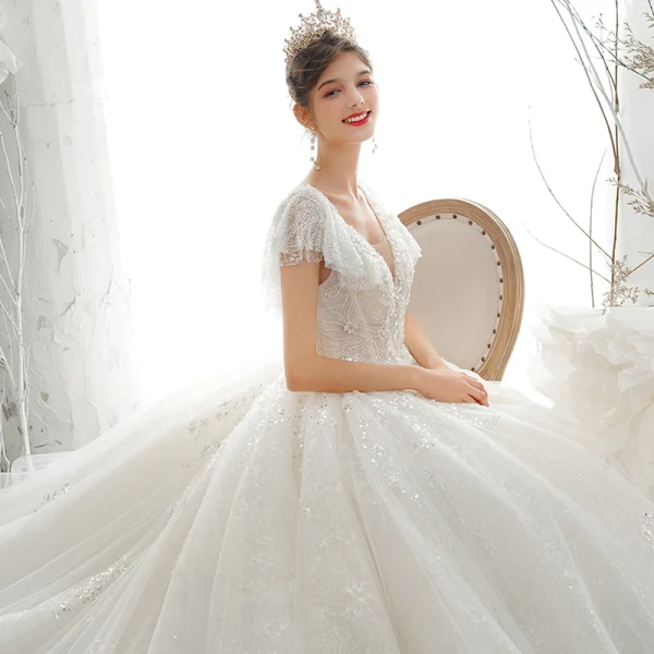 Luxury / Gorgeous Champagne Bridal Wedding Dresses 2020 Ball Gown See-through V-Neck Short Sleeve Backless Appliques Sequins Beading Cathedral Train Ruffle