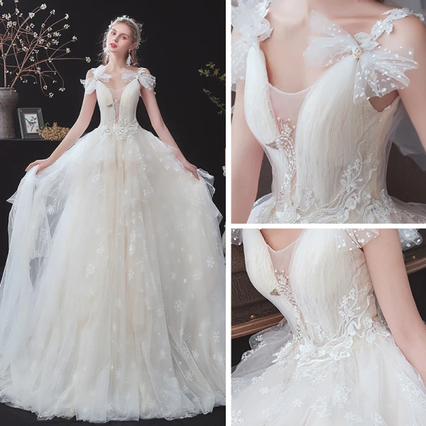Chic / Belle Champagne La Mariée Robe De Mariée 2020 Princesse Transparentes Col v profond Sans Manches Dos Nu Noeud Appliques En Dentelle Perlage Tribunal Train
