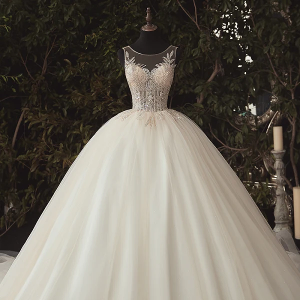 Illusion Ivoire La Mariée Robe De Mariée 2020 Robe Boule Transparentes Encolure Dégagée Sans Manches Dos Nu Appliques Paillettes Perlage Cathedral Train Volants