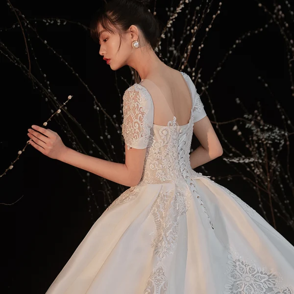 Vintage / Retro White Satin Bridal Wedding Dresses 2020 Ball Gown See-through Scoop Neck Short Sleeve Backless Beading Pierced Appliques Lace Cathedral Train