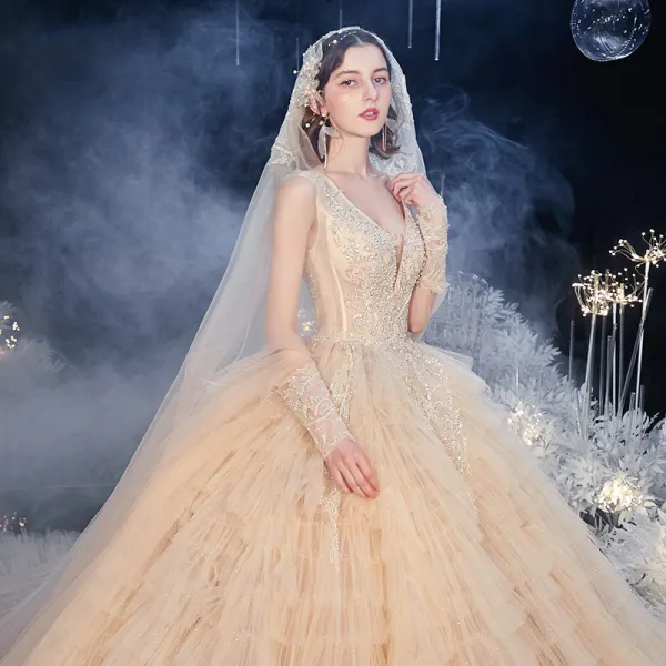 Stunning Champagne Bridal Wedding Dresses 2020 Ball Gown Deep V-Neck Long Sleeve Backless Appliques Beading Glitter Tulle Cathedral Train Cascading Ruffles