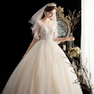Chic Beautiful Champagne Bridal Wedding Dresses 2020 Ball Gown See Through Scoop Neck 3 4 Sleeve Backless Appliques Beading Sweep Train Ruffle