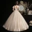 Élégant Champagne Robe De Mariée 2020 Robe Boule Transparentes Encolure Dégagée Noeud Manches Courtes Dos Nu Perlage Gland Glitter Tulle Longue Volants