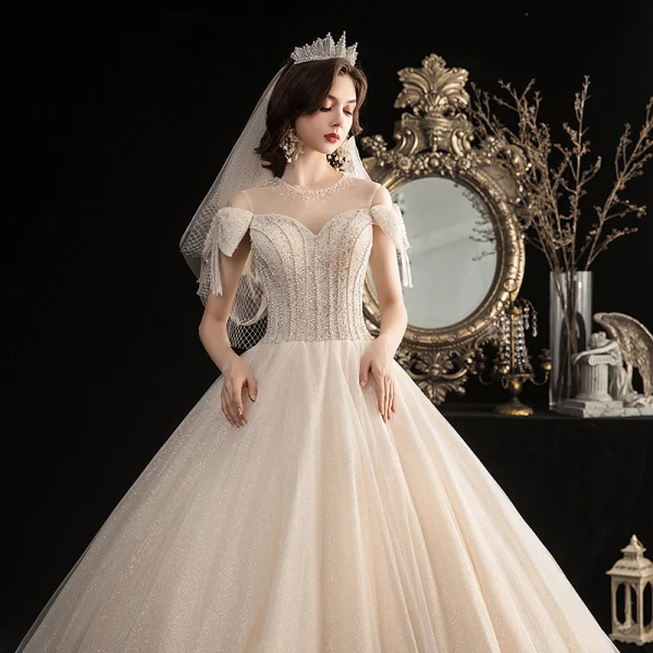 Élégant Champagne Robe De Mariée 2020 Robe Boule Transparentes Encolure Dégagée Noeud Manches Courtes Dos Nu Perlage Gland Glitter Tulle Longue Volants