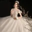 Élégant Champagne Robe De Mariée 2020 Robe Boule Transparentes Encolure Dégagée Noeud Manches Courtes Dos Nu Perlage Gland Glitter Tulle Longue Volants