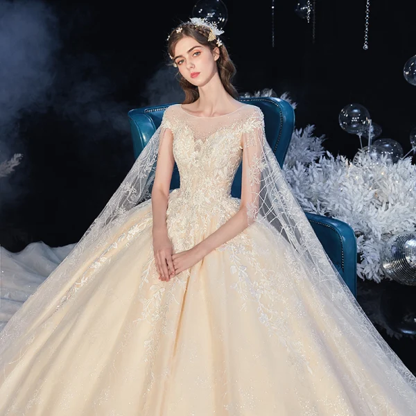 Romantic Champagne Bridal Wedding Dresses 2020 Ball Gown See-through Scoop Neck Short Sleeve Backless Appliques Lace Beading Crystal Cathedral Train Ruffle