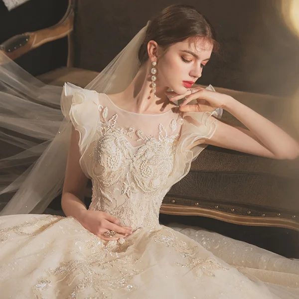 Chic / Belle Champagne La Mariée Robe De Mariée 2020 Robe Boule Transparentes Encolure Dégagée Sans Manches Dos Nu Appliques En Dentelle Perlage Glitter Tulle Chapel Train Volants