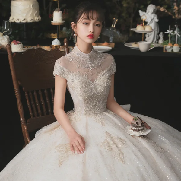 Luxury / Gorgeous Champagne Bridal Wedding Dresses 2020 Ball Gown See-through High Neck Short Sleeve Appliques Lace Beading Sequins Cathedral Train Ruffle