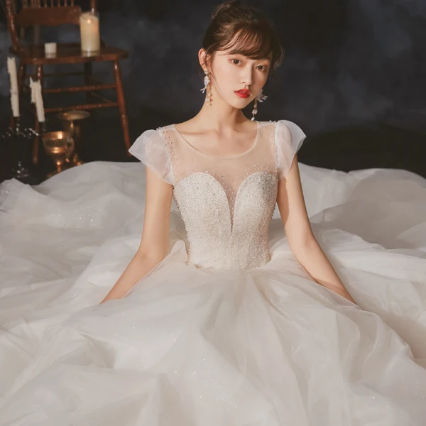 High-end Champagne Bridal Wedding Dresses 2020 Ball Gown See-through Scoop Neck Sleeveless Backless Beading Sequins Glitter Tulle Cathedral Train Ruffle