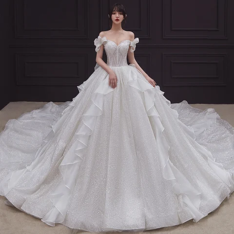 Romántico Champán Boda Vestidos De Novia 2020 Ball Gown Fuera Del Hombro Bowknot Manga Corta Sin Espalda Glitter Tul Cathedral Train Ruffle