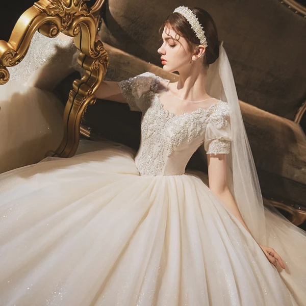 Vintage / Retro Audrey Hepburn Style Champagne Bridal Wedding Dresses 2020 Ball Gown See-through Scoop Neck Puffy Short Sleeve Backless Beading Glitter Tulle Chapel Train Ruffle