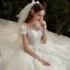 Style Victorien Ivoire La Mariée Robe De Mariée 2020 Robe Boule Transparentes Encolure Dégagée Gonflée Manches Courtes Dos Nu Appliques Fleur En Dentelle Perlage Paillettes Cathedral Train Volants