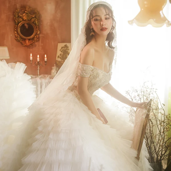 Stunning Champagne Bridal Wedding Dresses 2020 Ball Gown Off-The-Shoulder Short Sleeve Backless Beading Cascading Ruffles Cathedral Train