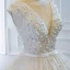 Luxe Ivoire La Mariée Robe De Mariée 2020 Robe Boule Transparentes Col v profond Sans Manches Dos Nu Appliques En Dentelle Perlage Perle Noeud Ceinture