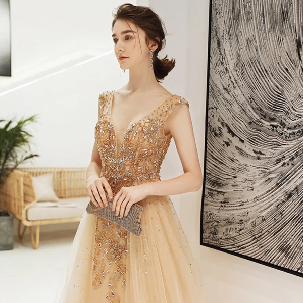 Sexy Champagne Col v profond Robe De Soirée 2020 Princesse Transparentes Sans Manches Faux Diamant Perlage Train De Balayage Dos Nu Volants Robe De Ceremonie