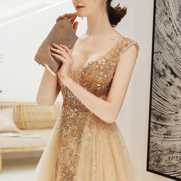 Sexy Champagne Col v profond Robe De Soirée 2020 Princesse Transparentes Sans Manches Faux Diamant Perlage Train De Balayage Dos Nu Volants Robe De Ceremonie
