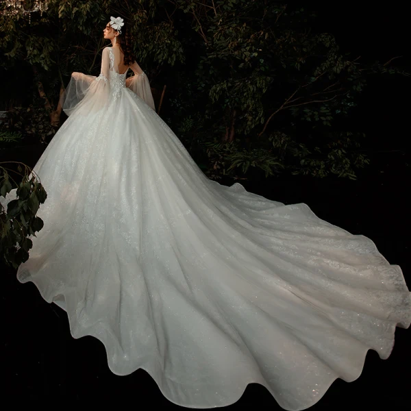 Romantique Champagne Robe De Mariée 2020 Robe Boule Transparentes Encolure Dégagée Manches de cloche Dos Nu Perlage Glitter Tulle Cathedral Train Volants