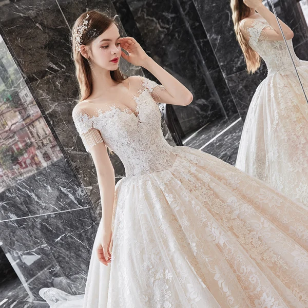 Charming Champagne Bridal Wedding Dresses 2020 Ball Gown See-through Scoop Neck Short Sleeve Beading Tassel Backless Appliques Lace Cathedral Train Ruffle