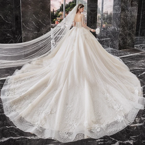 Meilleur Champagne La Mariée Robe De Mariée 2020 Robe Boule Transparentes Encolure Dégagée Manches Longues Dos Nu Paillettes Perlage Glitter Tulle Cathedral Train Volants
