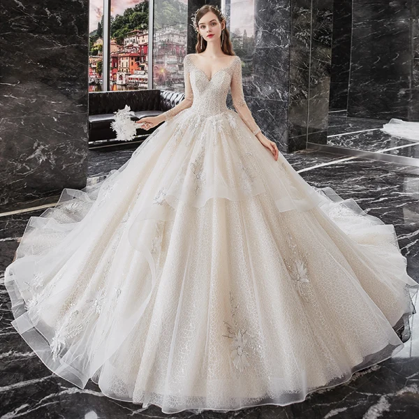 Meilleur Champagne La Mariée Robe De Mariée 2020 Robe Boule Transparentes Encolure Dégagée Manches Longues Dos Nu Paillettes Perlage Glitter Tulle Cathedral Train Volants